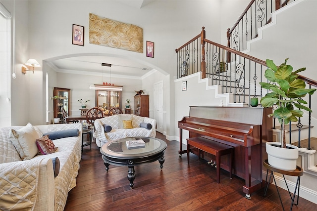 14766 Daneway Dr, Frisco, TX 75035 - living area featuring arched walkways, wood-type flooring, stairway, crown molding, and baseboards