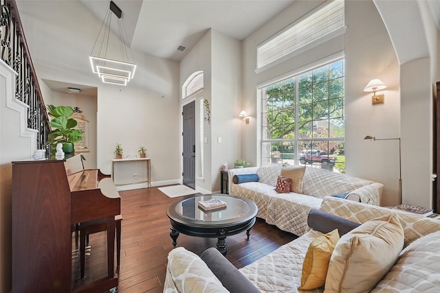 14766 Daneway Dr, Frisco, TX 75035 - living room with hardwood / wood-style floors, a towering ceiling, and baseboards