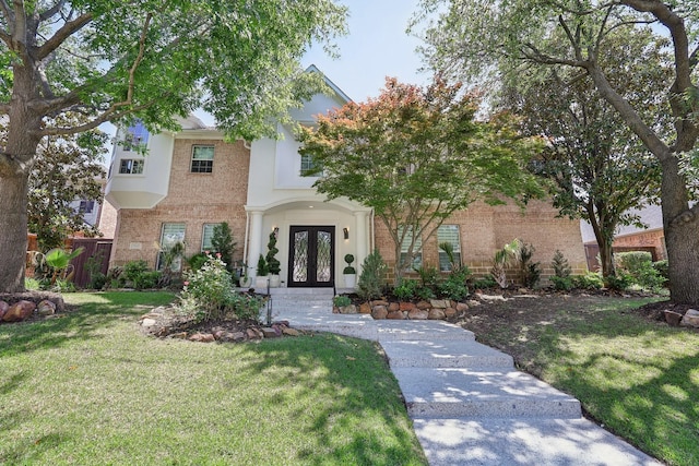 7012 Mills Branch Cir, Plano, TX 75024 - view of front of house with french doors, brick siding, and a front yard