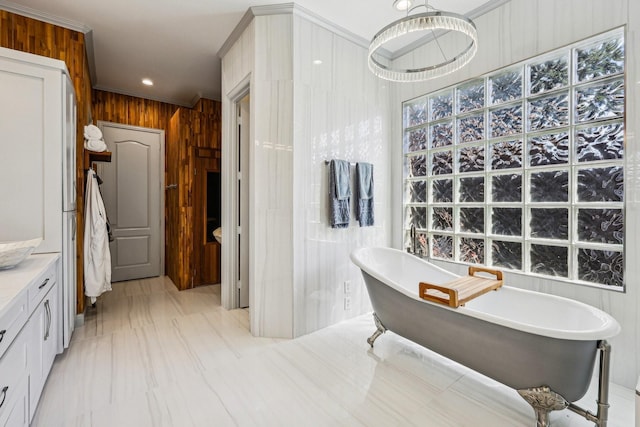 7012 Mills Branch Cir, Plano, TX 75024 - full bathroom featuring wood walls, a freestanding bath, ornamental molding, and vanity