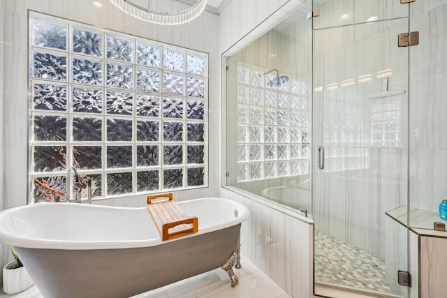 7012 Mills Branch Cir, Plano, TX 75024 - full bath with a stall shower, a soaking tub, and plenty of natural light