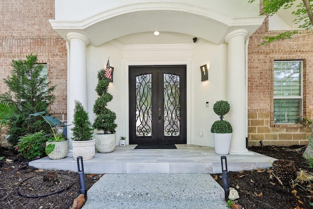 7012 Mills Branch Cir, Plano, TX 75024 - property entrance with french doors, brick siding, and a surveillance system