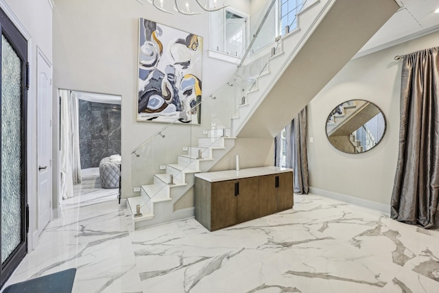 7012 Mills Branch Cir, Plano, TX 75024 - entrance foyer with stairway, marble tiled floors, a high ceiling, baseboards, and healthy amount of natural light