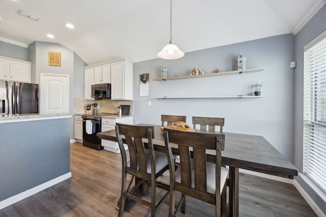 201 E St, Josephine, TX 75173 - dining space featuring lofted ceiling, wood finished floors, baseboards, recessed lighting, and crown molding