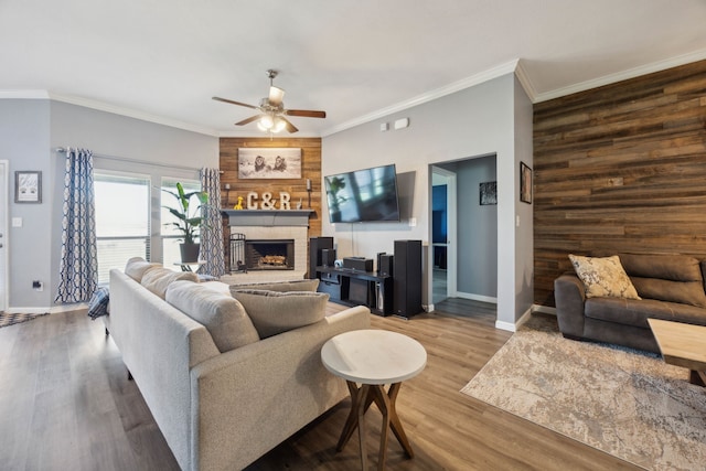 201 E St, Josephine, TX 75173 - living area featuring ceiling fan, baseboards, wood finished floors, a fireplace, and crown molding