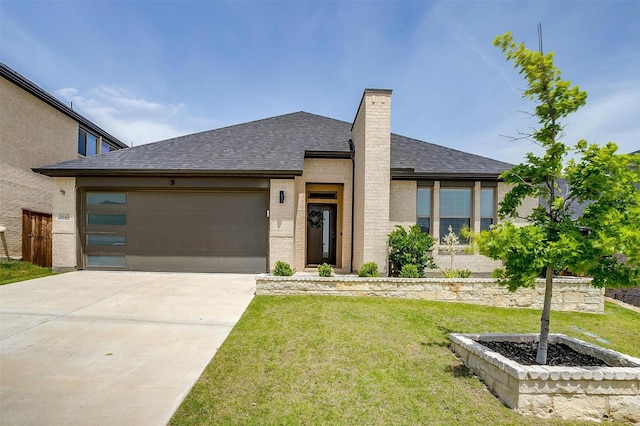view of front of home with a shingled roof, a garage, a front yard, and a chimney