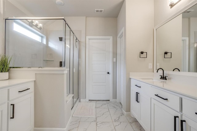 full bath with marble look tile flooring, a stall shower, vanity, and baseboards