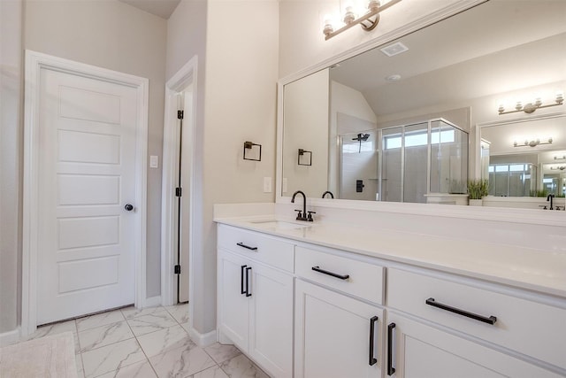 full bath featuring marble look tiles, a shower stall, vanity, baseboards, and lofted ceiling