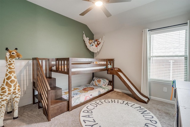 carpeted bedroom featuring lofted ceiling, a ceiling fan, and baseboards
