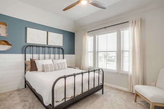 bedroom featuring multiple windows, light carpet, and ceiling fan
