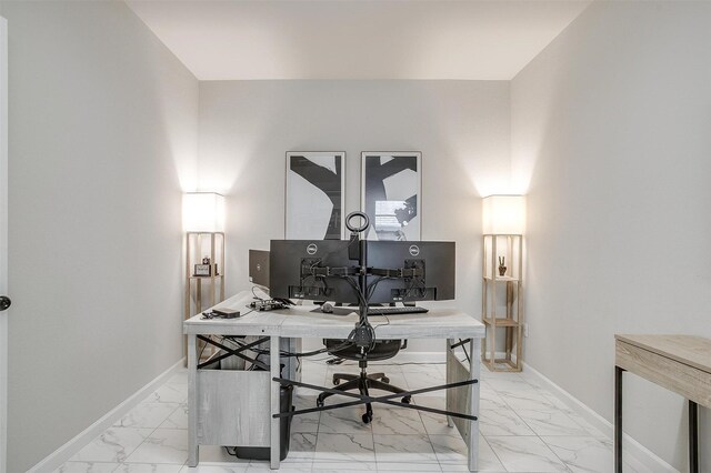 office featuring light marble finish floors and baseboards