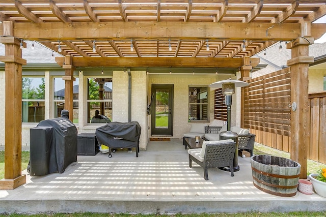 view of patio with area for grilling, fence, a pergola, and an outdoor hangout area