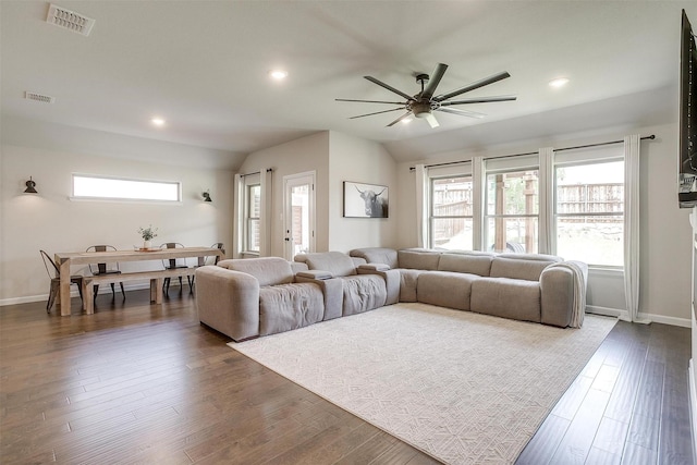 living room with a ceiling fan, vaulted ceiling, recessed lighting, baseboards, and dark wood finished floors
