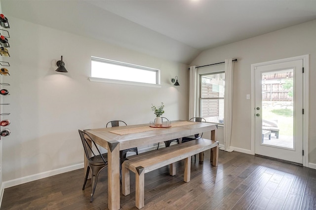 dining area with dark wood-style flooring, healthy amount of natural light, lofted ceiling, and baseboards