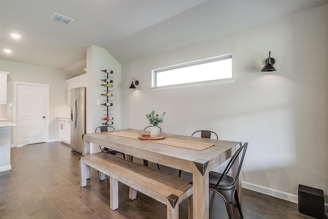 dining space featuring baseboards and dark wood finished floors