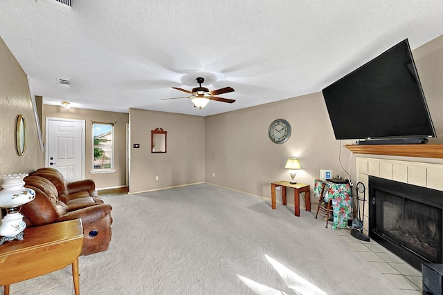 4821 Abbott Ave, Arlington, TX 76018 - living area with ceiling fan, a fireplace, a textured ceiling, carpet floors, and baseboards