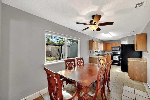4821 Abbott Ave, Arlington, TX 76018 - dining space with a ceiling fan, a textured ceiling, baseboards, and light tile patterned floors