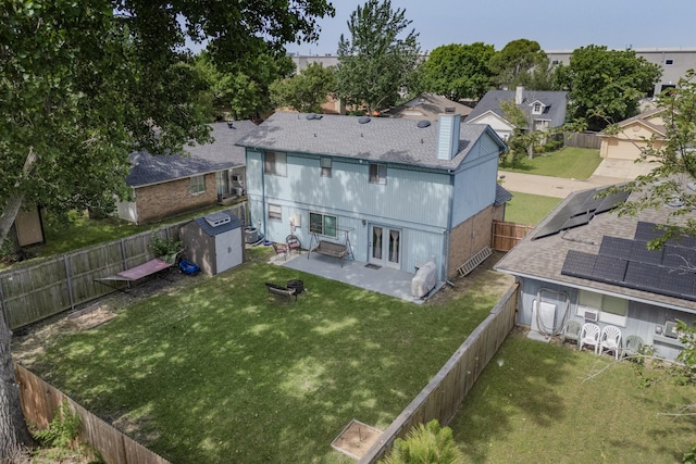 4821 Abbott Ave, Arlington, TX 76018 - rear view of house featuring a patio, a chimney, a shingled roof, and a shed