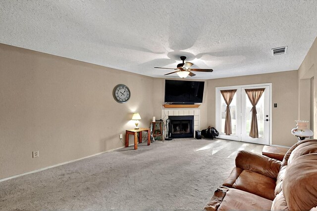 4821 Abbott Ave, Arlington, TX 76018 - living room with a ceiling fan, carpet, baseboards, a fireplace, and a textured ceiling