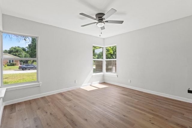 1304 Barnes Dr, Arlington, TX 76013 - unfurnished room with wood finished floors, ceiling fan, and baseboards