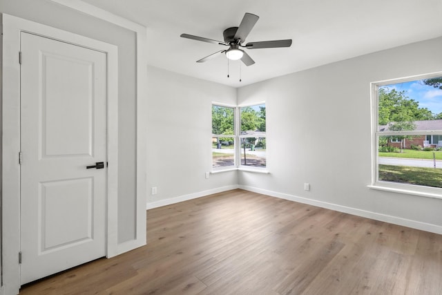 1304 Barnes Dr, Arlington, TX 76013 - unfurnished room with wood finished floors, plenty of natural light, and baseboards