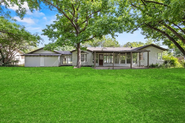 1304 Barnes Dr, Arlington, TX 76013 - rear view of house with a sunroom, a lawn, stone siding, and a patio area