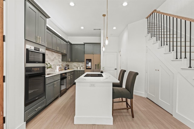2522 Jeffries St, Dallas, TX 75215 - kitchen with refrigerator with ice dispenser, gray cabinets, tasteful backsplash, light wood-type flooring, and recessed lighting