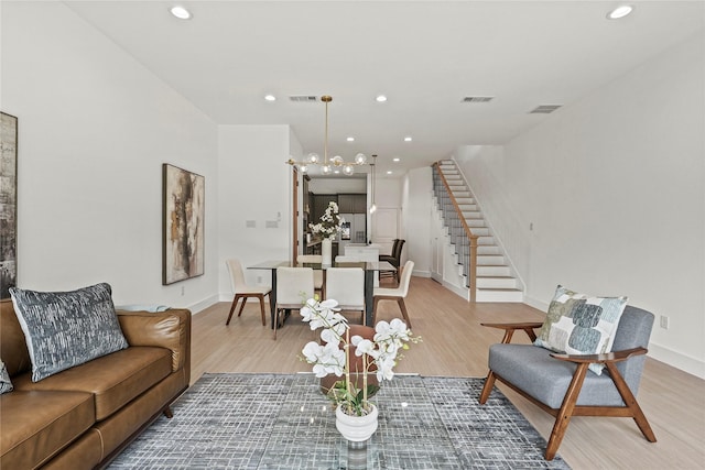 2522 Jeffries St, Dallas, TX 75215 - living room with stairs, light wood-style floors, a chandelier, recessed lighting, and baseboards