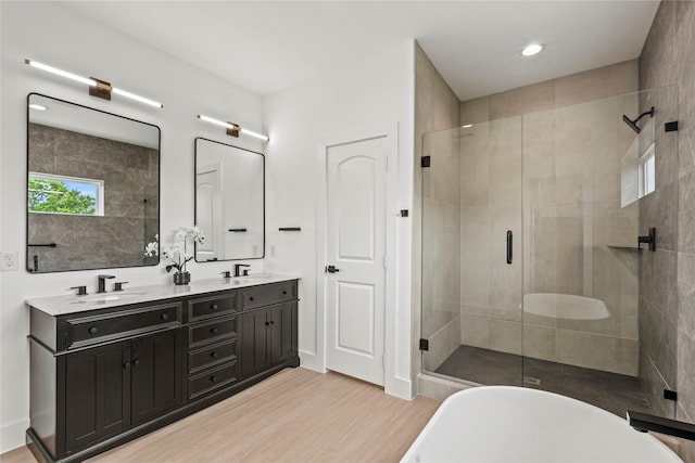 2522 Jeffries St, Dallas, TX 75215 - bathroom featuring a shower stall, wood finished floors, double vanity, a soaking tub, and recessed lighting