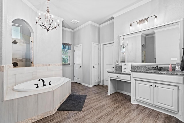 726 County Road 3355, Paradise, TX 76073 - full bathroom featuring a garden tub, vanity, a chandelier, healthy amount of natural light, and ornamental molding