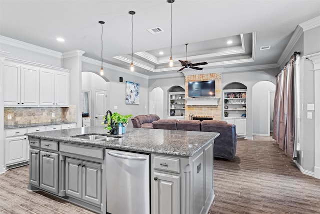 726 County Road 3355, Paradise, TX 76073 - kitchen with dishwasher, arched walkways, a sink, a ceiling fan, and a large fireplace