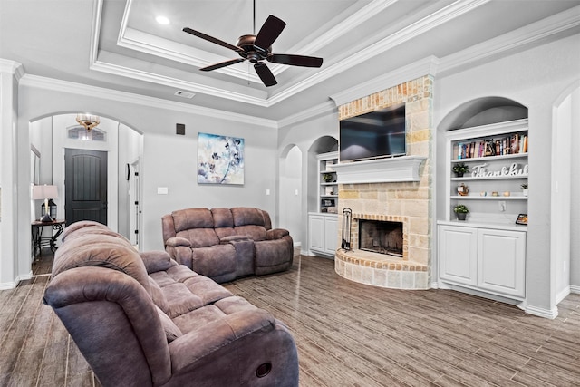 726 County Road 3355, Paradise, TX 76073 - living room with arched walkways, a raised ceiling, a ceiling fan, ornamental molding, and baseboards