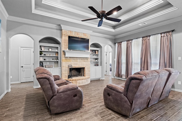 726 County Road 3355, Paradise, TX 76073 - living area featuring arched walkways, a raised ceiling, baseboards, crown molding, and wood finished floors