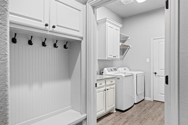 726 County Road 3355, Paradise, TX 76073 - laundry area featuring independent washer and dryer, cabinet space, and wood tiled floors
