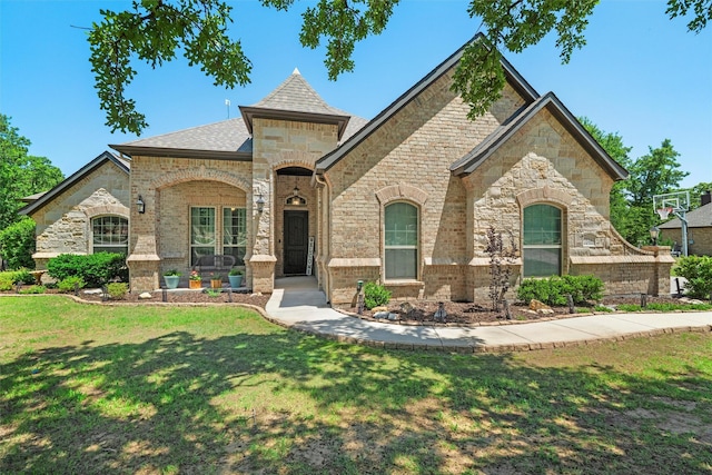 726 County Road 3355, Paradise, TX 76073 - french country style house featuring a front yard, brick siding, stone siding, and a shingled roof