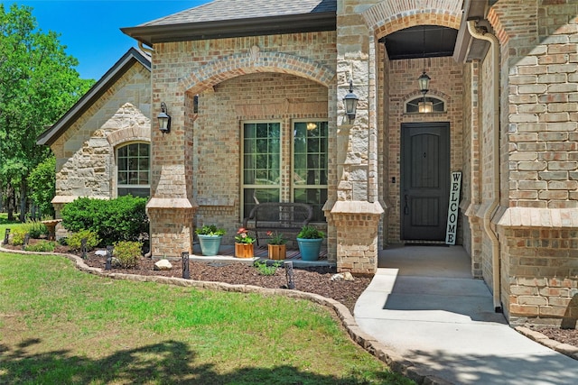 726 County Road 3355, Paradise, TX 76073 - view of exterior entry with brick siding, a shingled roof, and stone siding