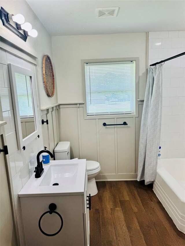900 Boyd Ave, Lindale, TX 75701 - full bathroom featuring wood finished floors, toilet, healthy amount of natural light, and vanity