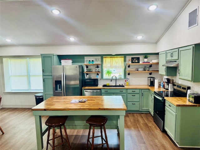 900 Boyd Ave, Lindale, TX 75701 - kitchen with green cabinetry, butcher block countertops, stainless steel appliances, a sink, and open shelves
