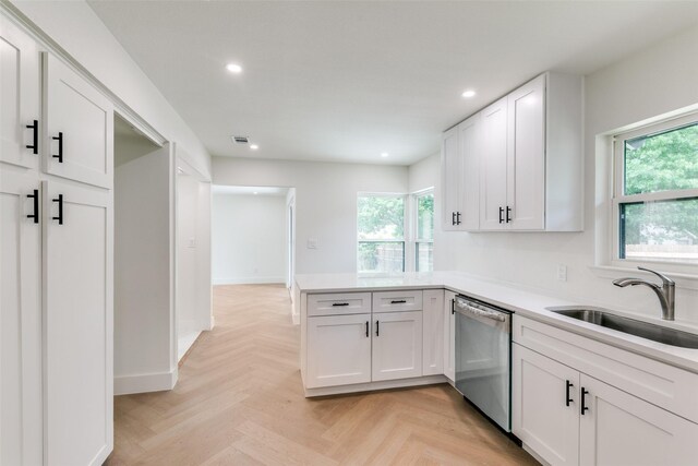 1447 Arizona Ave, Dallas, TX 75216 - kitchen with dishwasher, a sink, recessed lighting, healthy amount of natural light, and white cabinets