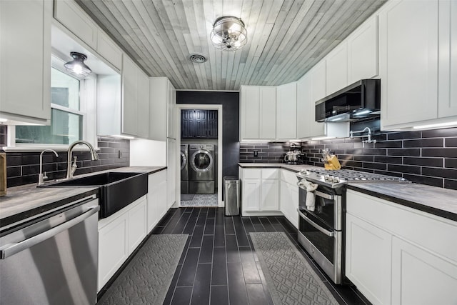 2902 Panhandle Dr, Grapevine, TX 76051 - kitchen featuring appliances with stainless steel finishes, independent washer and dryer, backsplash, white cabinetry, and wood ceiling