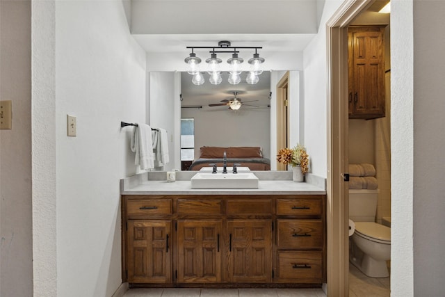 2902 Panhandle Dr, Grapevine, TX 76051 - bathroom featuring vanity, tile patterned floors, toilet, ceiling fan, and ensuite bathroom