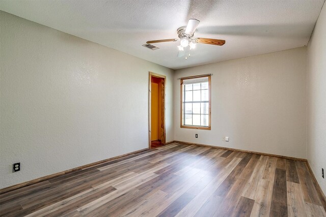 5101 County Road 1205, Cleburne, TX 76031 - spare room featuring wood finished floors, ceiling fan, baseboards, and a textured wall