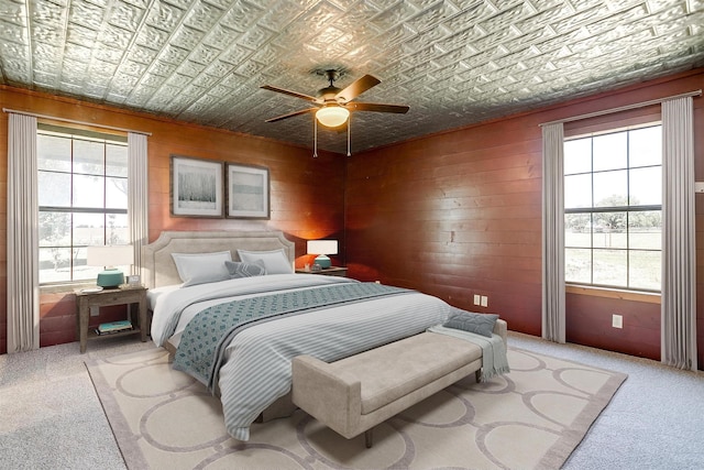 5101 County Road 1205, Cleburne, TX 76031 - carpeted bedroom featuring an ornate ceiling, a ceiling fan, and wooden walls
