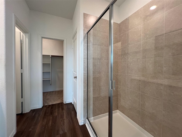 409 Petty Way, Fate, TX 75189 - full bathroom featuring a stall shower, wood finished floors, and a spacious closet