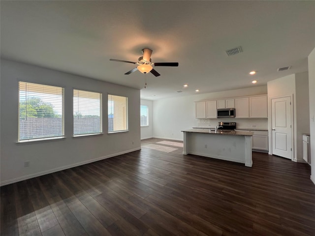 409 Petty Way, Fate, TX 75189 - kitchen featuring stainless steel appliances, open floor plan, white cabinets, recessed lighting, and baseboards