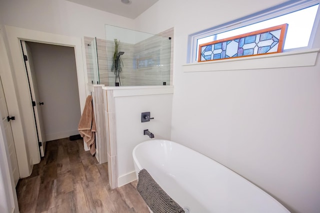 100 E 3rd St, Tolar, TX 76476 - full bathroom with a freestanding tub, a walk in shower, wood finished floors, and baseboards