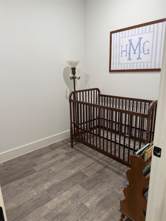 100 E 3rd St, Tolar, TX 76476 - bedroom with wood finished floors and baseboards