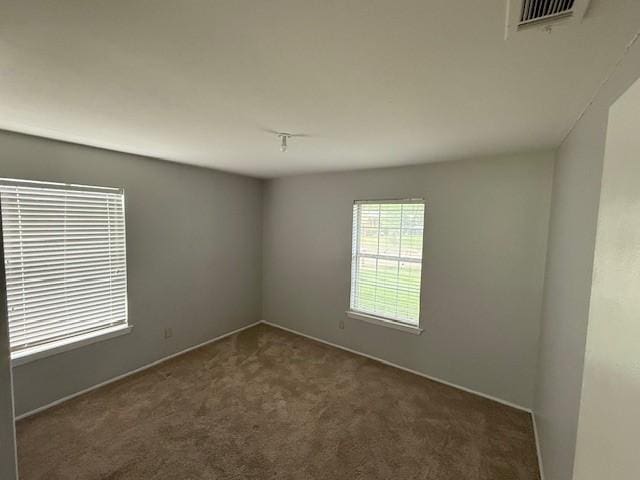 empty room with carpet flooring and baseboards
