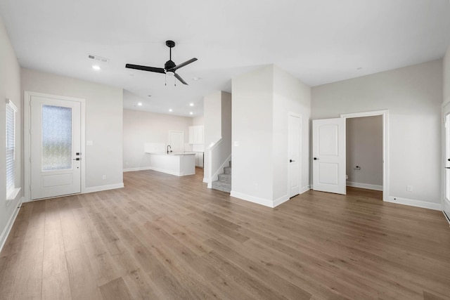 736 Carson Ln, Pilot Point, TX 76258 - unfurnished living room featuring light wood-style flooring, stairs, ceiling fan, baseboards, and recessed lighting