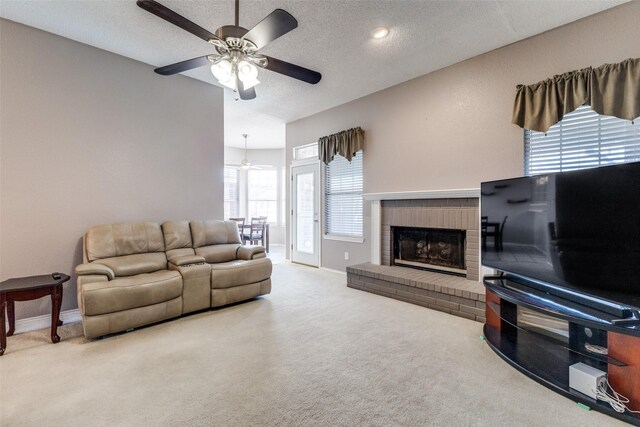 1729 Sheffield Dr, Garland, TX 75040 - living room with ceiling fan, carpet flooring, baseboards, a fireplace, and a textured ceiling